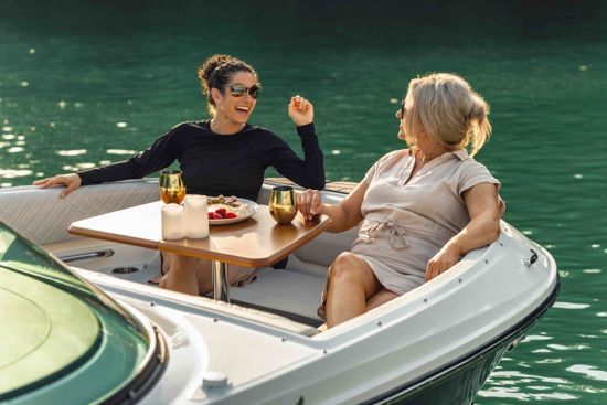enjoying drinks and snacks on the bow seating area of a Sea Ray 230 SDX OB